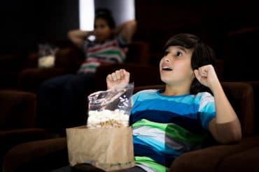 Child at the cinema watching movie